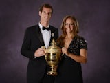 Andy Murray poses with the 2013 Wimbledon trophy along with his girlfriend Kim Sears during the Wimbledon Champions Dinner in Central London on July 7, 2013