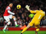 Alex Oxlade-Chamberlain of Arsenal scores the first goal past Julian Speroni of Crystal Palace during the Barclays Premier League match between Arsenal and Crystal Palace at Emirates Stadium on February 2, 2014 