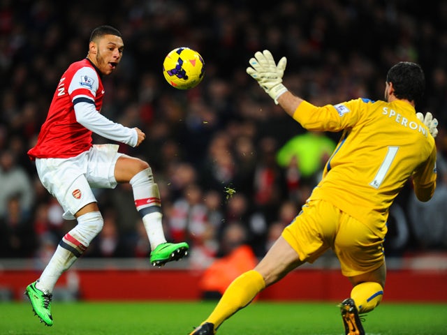 Alex Oxlade-Chamberlain of Arsenal scores the first goal past Julian Speroni of Crystal Palace during the Barclays Premier League match between Arsenal and Crystal Palace at Emirates Stadium on February 2, 2014 