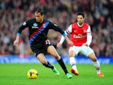 Marouane Chamakh of Crystal Palace is marshalled by Mikel Arteta of Arsenal during the Barclays Premier League match between Arsenal and Crystal Palace at Emirates Stadium on February 2, 2014