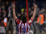 Atletico Madrid's forward David Villa celebrates after scoring the opener during the Spanish league football match Club Atletico de Madrid vs Real Sociedad at the Vicente Calderon stadium in Madrid on February 2, 2014