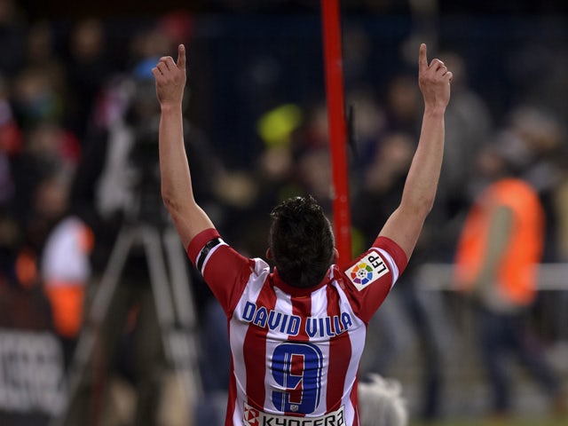 Atletico Madrid's forward David Villa celebrates after scoring the opener during the Spanish league football match Club Atletico de Madrid vs Real Sociedad at the Vicente Calderon stadium in Madrid on February 2, 2014