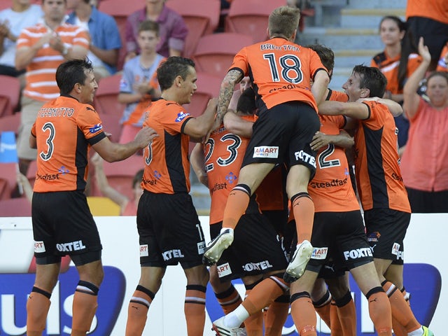 Henrique of the Roar and team mates celebrate after he scores a goal during the round 17 A-League match between Brisbane Roar and the Central Coast Mariners at Suncorp Stadium on February 2, 2014