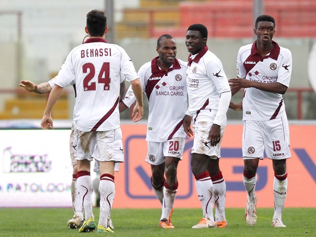 Innocent Emeghara of Livorno celebrates with his team-mates after scoring the opening goal during the Serie A match between Calcio Catania and AS Livorno Calcio at Stadio Angelo Massimino on February 2, 2014 