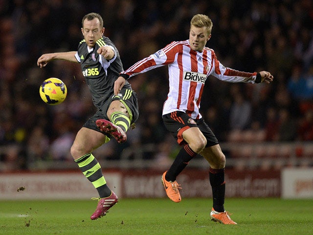 Sunderland's Sebastian Larsson and Stoke's Charlie Adam in action during their Premier League match on January 29, 2014
