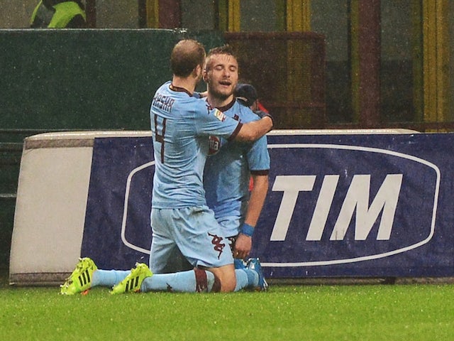 Torino's forward Ciro Immobile celebrates after scoring a goal with teammate Swiss midfielder Migjen Basha during the Serie A football match against AC Milan on February 1, 2014