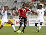 Libya's player Elhouni (C) vies for the ball with Ghana's players Jordan Opoku (R) and Joshua Tijani (L) during the African Nations Championship final on February 1, 2014