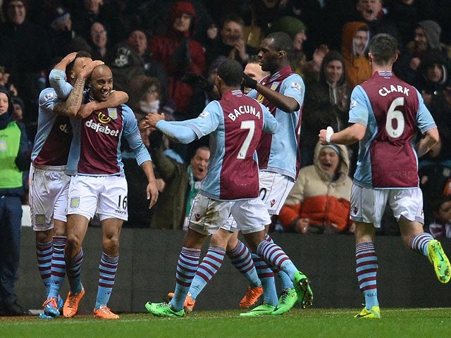 Aston Villa's Fabian Delph is congratulated by teammates after scoring his team's third goal against West Brom during their Premier League match on January 29, 2014