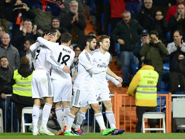 Real's Jese Rodriguez Ruiz celebrates with teammates after scoring the opening goal against Espanyol during their Copa del Rey quarter-final match on January 28, 2014