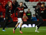 Manchester United's Spanish midfielder Juan Mata waves as he runs onto the pitch to warm-up ahead of the English Premier League football match between Manchester United and Cardiff City at Old Trafford in Manchester, northwest England, on January 28, 2014