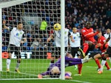 Kenwyne Jones of Cardiff City beats goalkeeper John Ruddy of Norwich City to score their second goal during the Barclays Premier League match on February 1, 2014