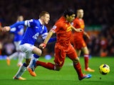 Luis Suarez of Liverpoolis pursued by James McCarthy of Everton during the Barclays Premier League match between Liverpool and Everton at Anfield on January 28, 2014