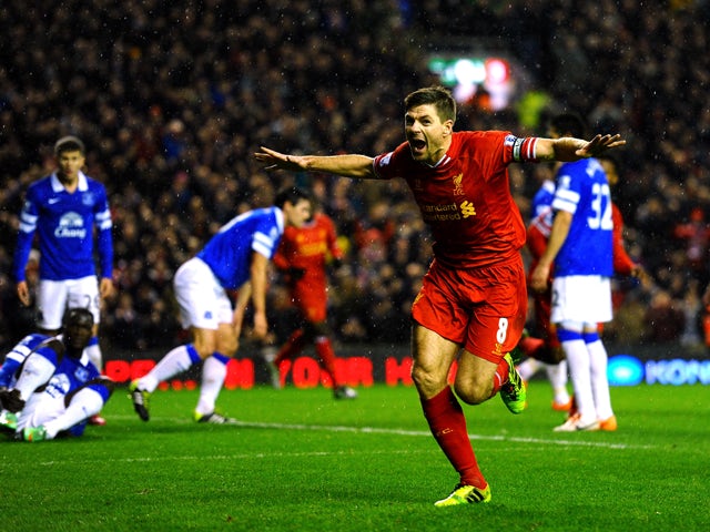 Steven Gerrard of Liverpool celebrates after scoring the opening goal during the Barclays Premier League match between Liverpool and Everton at Anfield on January 28, 2014
