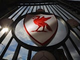 The Liverpool Football Club emblem is displayed on the gates of Anfield Stadium on September 17, 2012