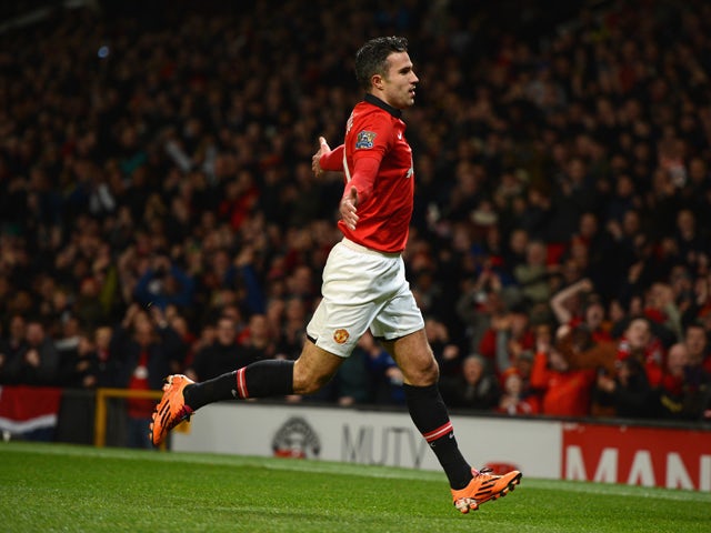 Robin van Persie of Manchester United celebrates scoring the opening goal during the Barclays Premier League match between Manchester United and Cardiff City at Old Trafford on January 28, 2014