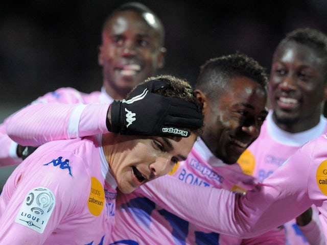 Evian's Argentinian forward Marco Ruben is congratulated by teammates after scoring during their French L1 football match against Ajaccio on February 1, 2014