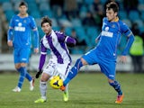 Miguel Marcos alias Michel (R) of Getafe CF competes for the ball with Victor Perez (L) of Real Valladolid CF during the La Liga match on February 1, 2014