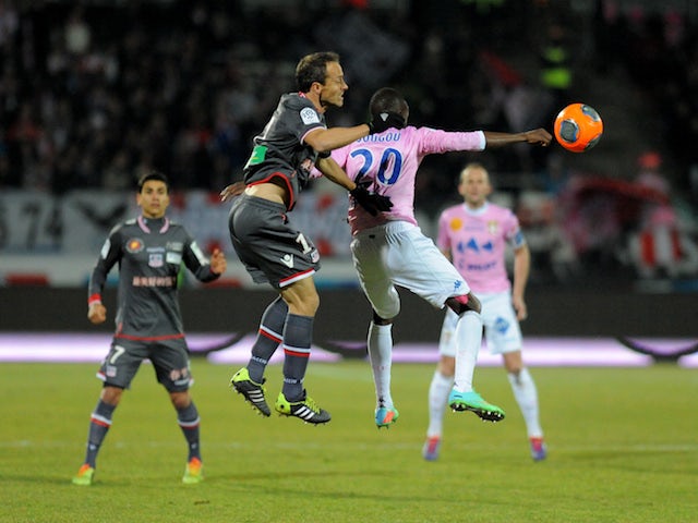 Evian's Senegalese forward Modou Sougou vies with Ajaccio's French defender Laurent Bonnart during their French L1 football match on February 1, 2014