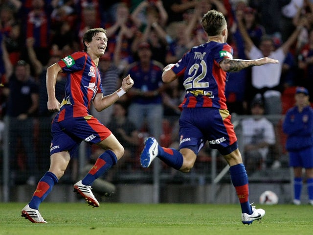 Adam Taggart and Craig Goodwin of the Jets celebrate a goal during the round 17 A-League match between Newcastle Jets and the Western Sydney Wanderers at Hunter Stadium on February 1, 2014