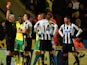 Referee Chris Foy shows Loic Remy of Newcastle United a red card during the Barclays Premier League match between Norwich City and Newcastle United at Carrow Road on January 28, 2014