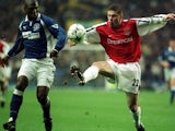 Oleg Luzhny attempts to win possession from Kevin Campbell on November 18, 2000.