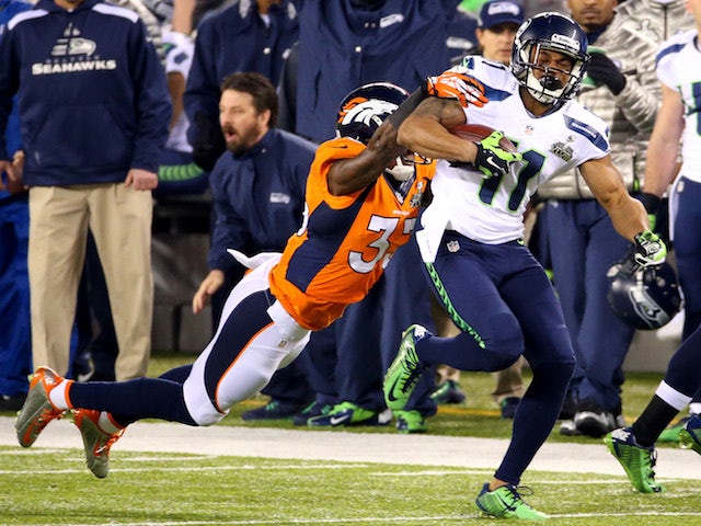 Wide receiver Percy Harvin #11 of the Seattle Seahawks runs the ball against strong safety Duke Ihenacho #33 of the Denver Broncos  on February 2, 2014