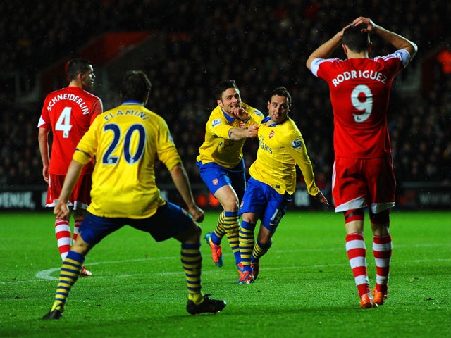 Santi Cazorla of Arsenal celebrates scoring their second goal with Olivier Giroud of Arsenal during the Barclays Premier League match between Southampton and Arsenal at St Mary's Stadium on January 28, 2014 