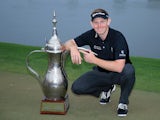 Stephen Gallacher of Scotland with the trophy after the final round where he became the first back to back winner of the Omega Dubai Desert Classic on the Majlis Course at the Emirates Golf Club on February 2, 2014 