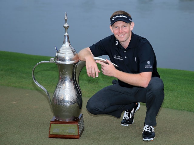 Stephen Gallacher of Scotland with the trophy after the final round where he became the first back to back winner of the Omega Dubai Desert Classic on the Majlis Course at the Emirates Golf Club on February 2, 2014 