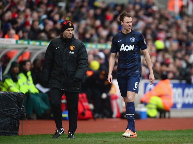 Jonny Evans of Manchester United leaves the field with an injury during the Barclays Premier League match between Stoke City and Manchester United at Britannia Stadium on February 1, 2014