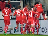 Bayern Munich's Thiago is mobbed by teammates after scoring his team's second goal against Stuttgart during their Bundesliga match on January 29, 2014