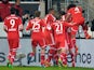 Bayern Munich's Thiago is mobbed by teammates after scoring his team's second goal against Stuttgart during their Bundesliga match on January 29, 2014