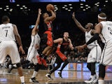 Toronto Raptors Terrence Ross shoots over Brooklyn Nets Kevin Garnett during their NBA game at the Barclays Center on January 27, 2014