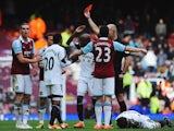 Andy Carroll of West Ham United is sent off by referee Howard Webb after a clash with Chico Flores of Swansea City (R) during the Barclays Premier League match between West Ham United and Swansea City at Boleyn Ground on February 1, 2014