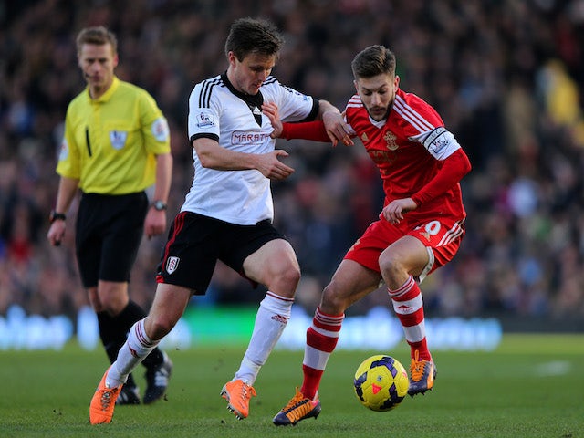 William Kvist (L) of Fulham in action against Adam Lallana of Southampton during the Barclays Premier League on February 1, 2014