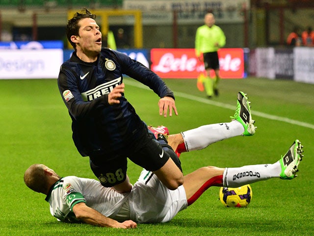 Inter's Anderson Hernanes is tackled by Sassuolo's Paolo Bianco during their Serie A match on February 9, 2014