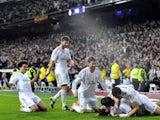 Real Madrid's Argentinian midfielder Angel di Maria (R) is congratuled by his teammates after scoring during the Spanish Copa del Rey (King's Cup) semifinal first-leg football match on February 5, 2014