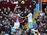 Christian Benteke of Aston Villa and Guy Demel of West Ham United contest a header during the Barclays Premier League match between Aston Villa and West Ham United at Villa Park on February 8, 2014