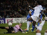 Lyon's French forward Bafetimbi Gomis (R) shoots and scores against Troyes' French goalkeeper Matthieu Dreyer (L) during the French League Cup semi-final football match on February 5, 2014