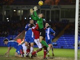 Bobby Olejnik of Peterborough United saves from Nile Ranger of Swindon Town during the Johnstone's Paint Southern Area Final on February 5, 2014