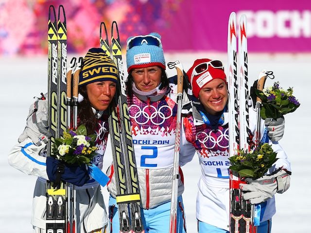 Sweden's Charlotte Kalla (silver), Norway's Marit Bjoergen (gold) and Norway's Heidi Weng (bronze) on the podium on February 8, 2014.