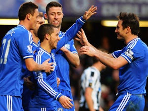 Eden Hazard of Chelsea is congratulated by team mates including Frank Lampard after scoring his third goal from the penalty spot during the Barclays Premier League match between Cheslea and Newcastle United at Stamford Bridge on February 8, 2014