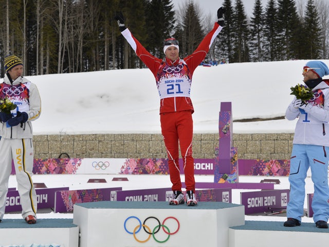 Gold winner Switzerland's Dario Cologna celebrates after the Men's Cross-Country Skiing 15km + 15km Skiathlon at the Laura Cross-Country Ski and Biathlon Center during the Sochi Winter Olympics on February 9, 2014