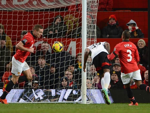 Fulham's Darren Bent heads in a late equaliser against Manchester United during their Premier League match on February 9, 2014