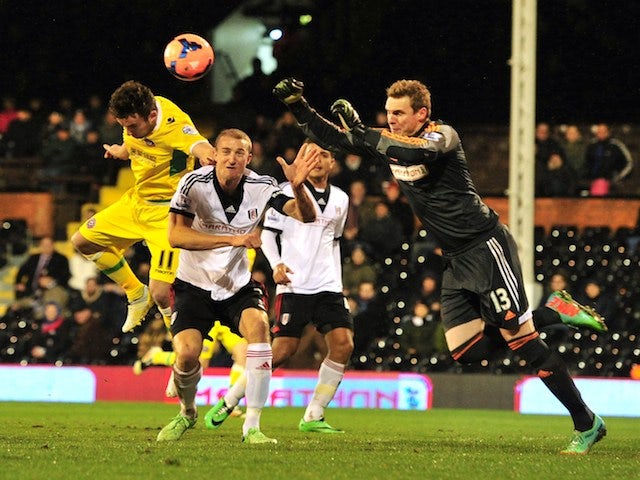 Fulham's English goalkeeper David Stockdale (R) comes to claim a cross during the English FA Cup fourth round replay football match against Sheffield United on February 4, 2014