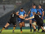 Ollie Barkley of Grenoble is tackled by Tom Lindsay and Jake Cooper-Woolley of London Wasps during the Amlin Challenge Cup match between London Wasps and Grenoble at Adams Park on December 15, 2013