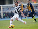 Juventus' Argentinian forward Carlos Tevez shoots and scores his second goal during the Italian Serie A football match Hellas Verona Vs Juventus on February 9, 2014