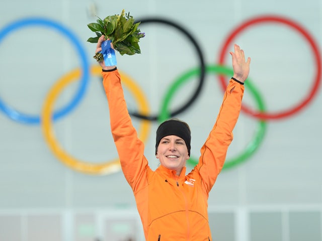 Netherlands' Irene Wust poses on the podium after winning the gold medal in the Women's Speed Skating 3000 m Flower Ceremony at the Adler Arena during the Sochi Winter Olympics on February 9, 2014