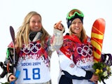 Gold medalist Jamie Anderson of the United States and bronze medalist Jenny Jones of Great Britain celebrate during the flower ceremony for the Women's Snowboard Slopestyle event at the 2014 Winter Olympics in Sochi, Russia