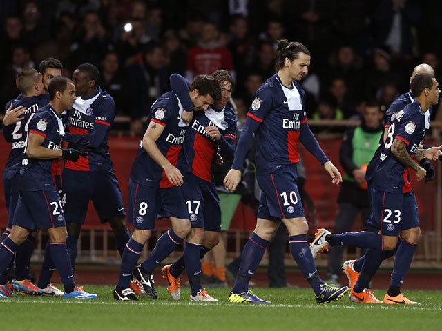 PSG's Javier Pastore is congratulated by teammates after scoring the opening goal against Monaco on February 9, 2014